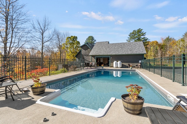 view of swimming pool with a patio and an outdoor structure