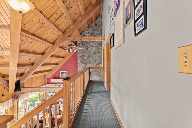 corridor with wood ceiling, vaulted ceiling with beams, and carpet floors