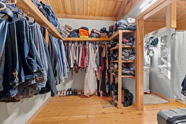 walk in closet with hardwood / wood-style flooring