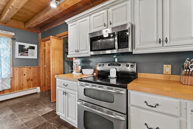 kitchen with wooden ceiling, white cabinets, beam ceiling, stainless steel appliances, and butcher block countertops