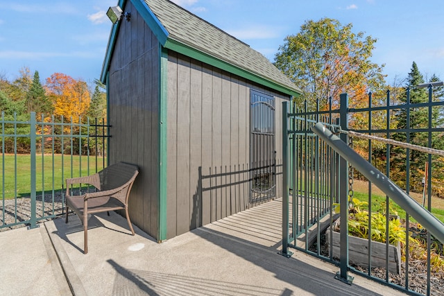 view of outbuilding featuring a lawn