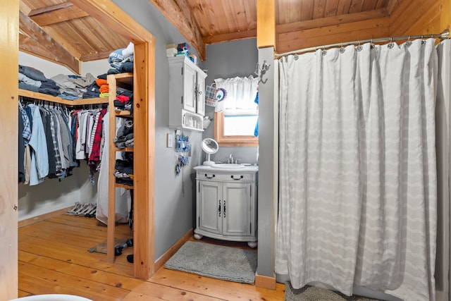 bathroom featuring hardwood / wood-style flooring, vanity, lofted ceiling with beams, and wood ceiling