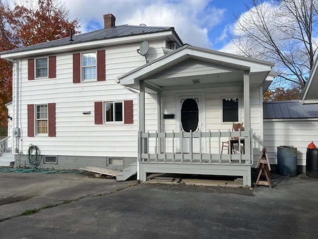 37 Spruce St, East Millinocket, ME 04430 - view of front of property featuring a chimney and a metal roof