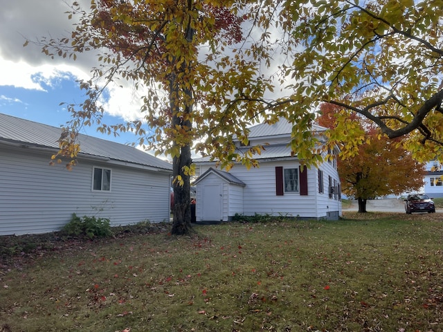 37 Spruce St, East Millinocket, ME 04430 - view of home's exterior with a lawn and a metal roof