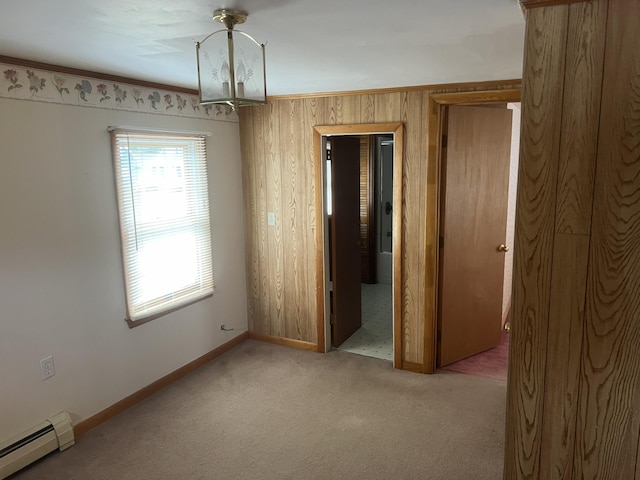 37 Spruce St, East Millinocket, ME 04430 - spare room featuring baseboard heating, wood walls, and carpet floors
