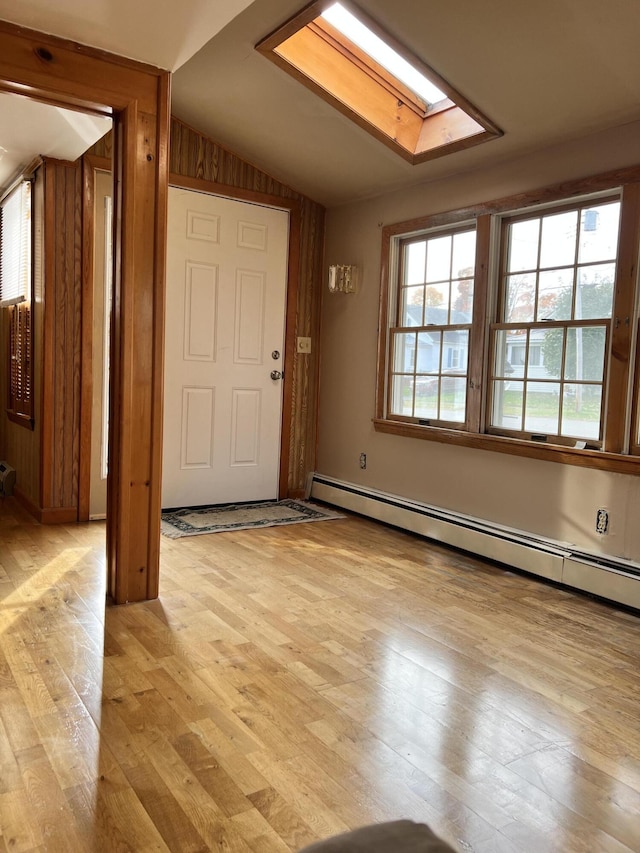 37 Spruce St, East Millinocket, ME 04430 - entryway featuring lofted ceiling, baseboard heating, light wood-style flooring, and a skylight