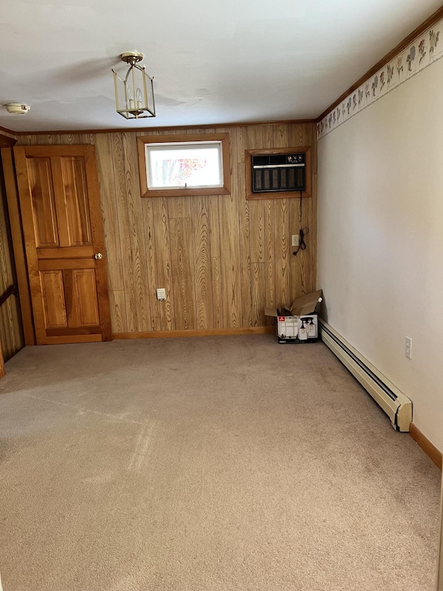 37 Spruce St, East Millinocket, ME 04430 - unfurnished room featuring a baseboard heating unit, light carpet, wood walls, a wall unit AC, and a smoke detector