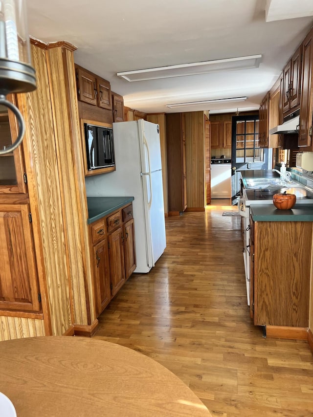 37 Spruce St, East Millinocket, ME 04430 - kitchen featuring range with electric stovetop, under cabinet range hood, light wood finished floors, and dark countertops