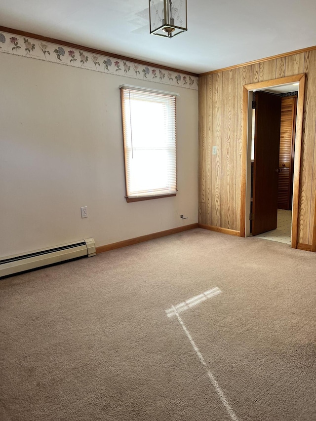 37 Spruce St, East Millinocket, ME 04430 - carpeted empty room featuring a baseboard heating unit and wooden walls
