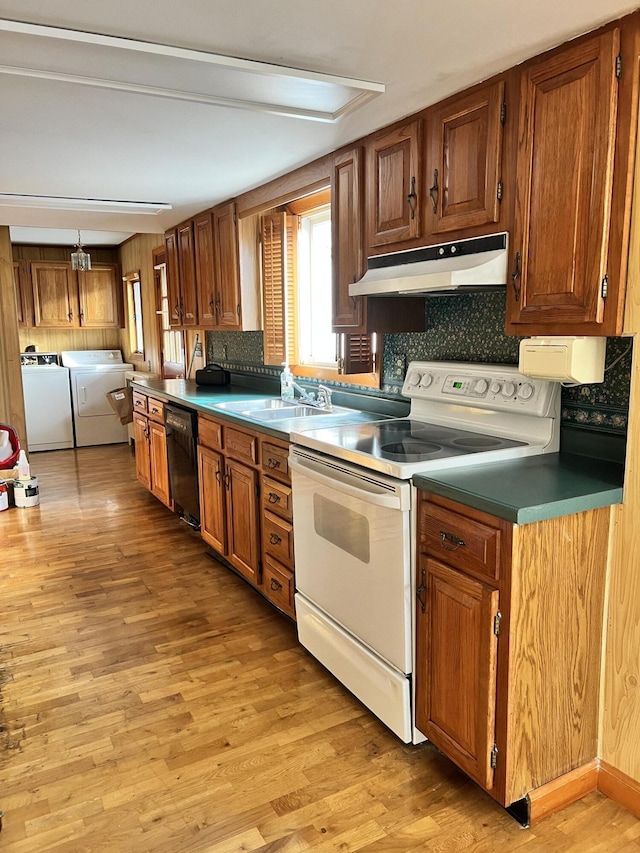 37 Spruce St, East Millinocket, ME 04430 - kitchen with electric range, under cabinet range hood, black dishwasher, independent washer and dryer, and light wood finished floors