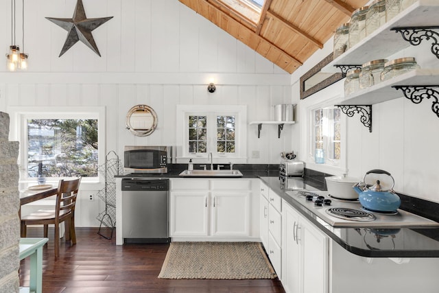 kitchen featuring appliances with stainless steel finishes, dark hardwood / wood-style flooring, sink, wooden ceiling, and white cabinetry