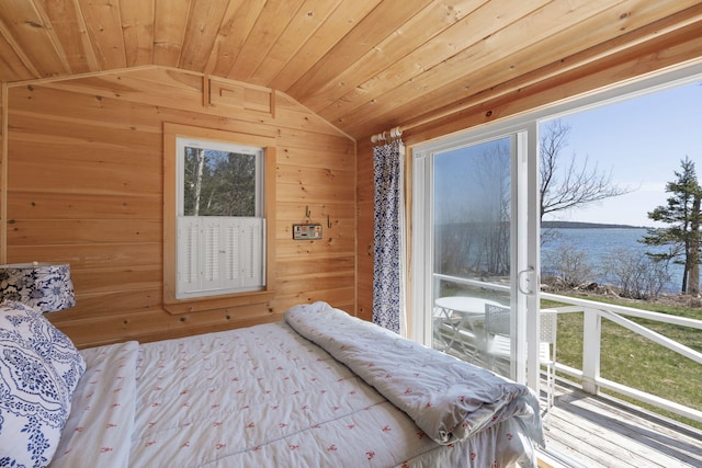 bedroom with wooden walls, a water view, wooden ceiling, and lofted ceiling