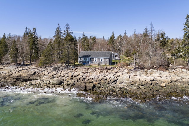 rear view of house featuring a water view