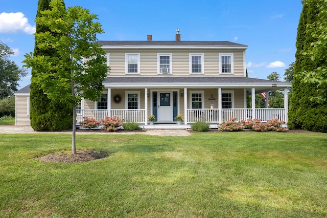 view of front of property featuring a front lawn and covered porch