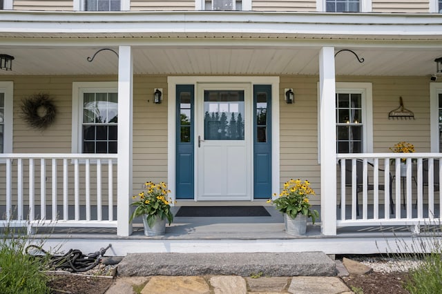 view of exterior entry with a porch