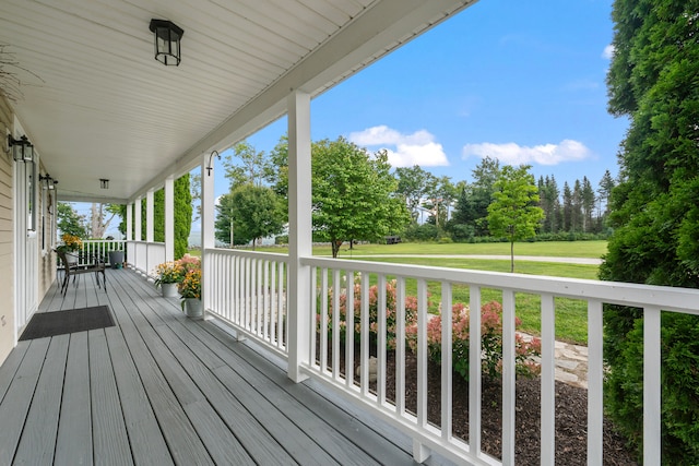 deck featuring a lawn and covered porch