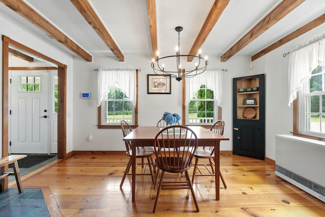 dining room featuring beam ceiling, an inviting chandelier, and light hardwood / wood-style floors