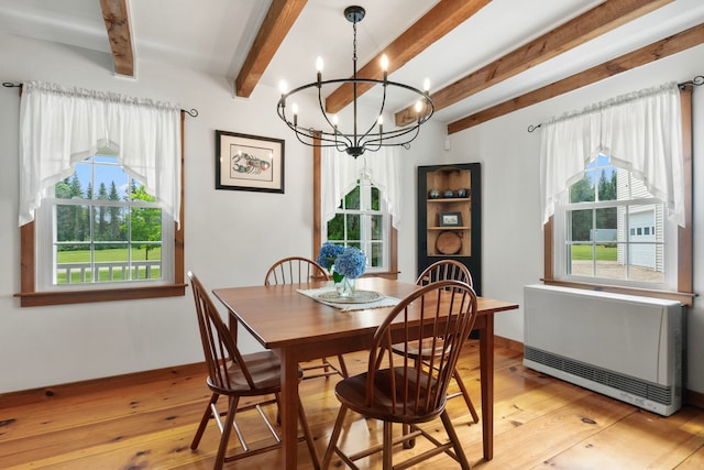 dining area featuring an inviting chandelier, beam ceiling, light hardwood / wood-style flooring, and a wealth of natural light