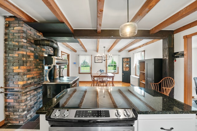 kitchen with pendant lighting, white cabinets, beam ceiling, a kitchen island, and electric range