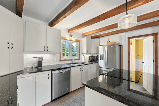 kitchen with beam ceiling, sink, hanging light fixtures, white cabinets, and appliances with stainless steel finishes