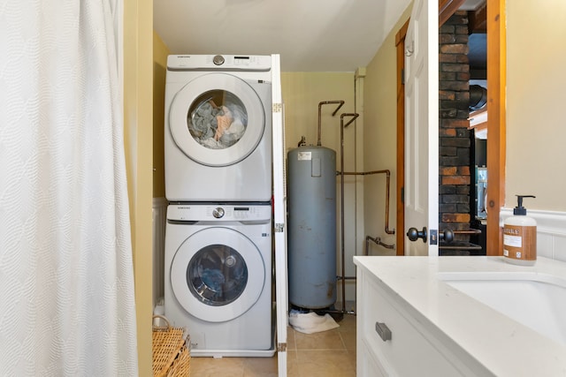 laundry room with stacked washer and dryer, water heater, and light tile patterned floors