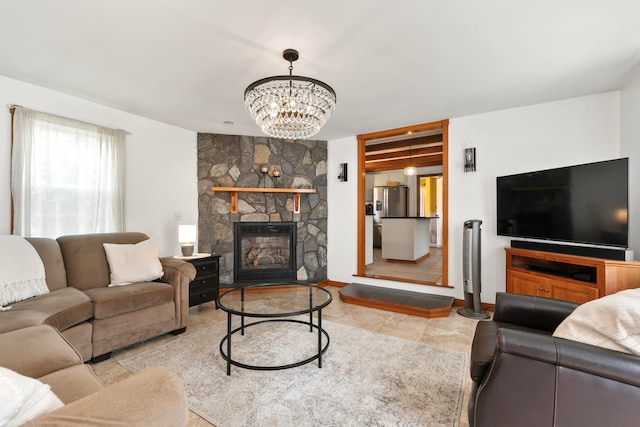 living room featuring a notable chandelier and a stone fireplace