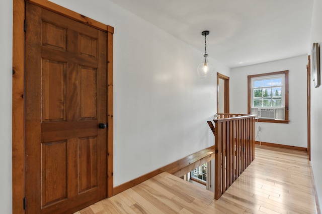 hallway featuring cooling unit and light hardwood / wood-style floors