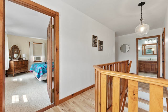 hallway featuring cooling unit and light hardwood / wood-style floors