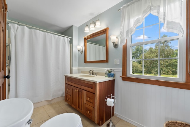 bathroom with tile patterned floors, vanity, walk in shower, and toilet