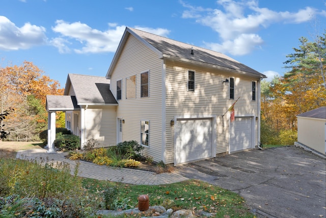 view of side of property with a garage