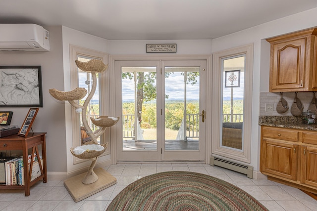 doorway with light tile patterned flooring, a baseboard heating unit, and an AC wall unit