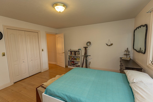 bedroom with a closet and light hardwood / wood-style flooring