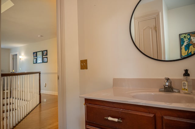 bathroom featuring hardwood / wood-style flooring and vanity