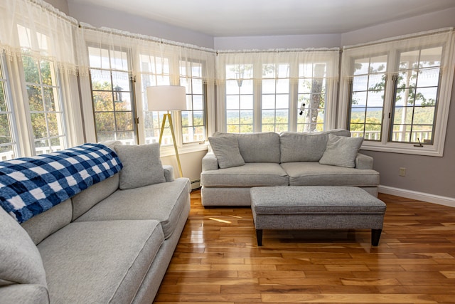 sunroom with a baseboard heating unit