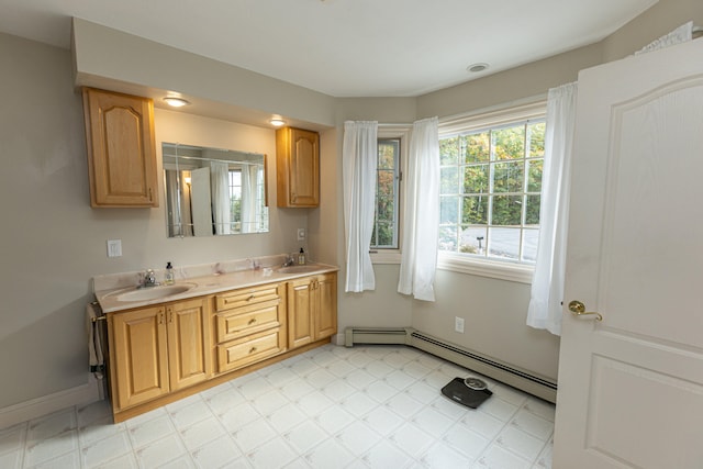 bathroom with vanity and baseboard heating