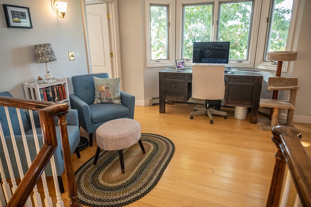 office space with light wood-type flooring and a baseboard radiator