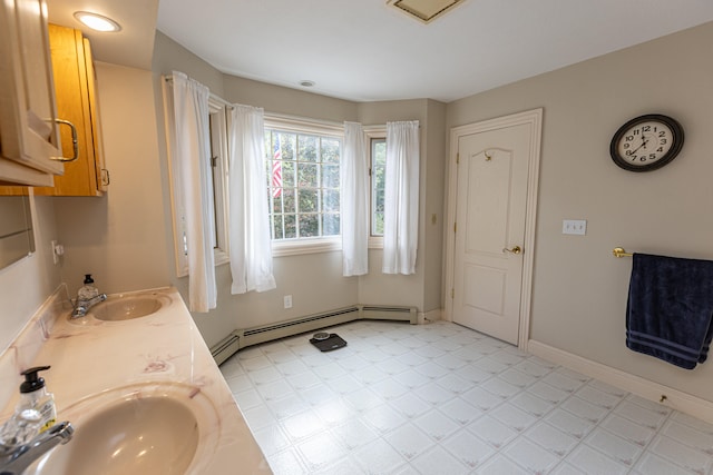 bathroom featuring vanity and baseboard heating