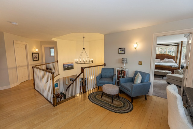 sitting room featuring a chandelier and light hardwood / wood-style flooring