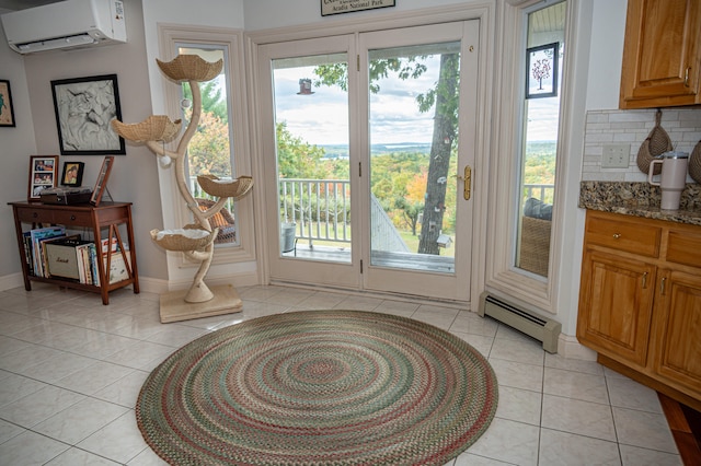 doorway to outside with a baseboard radiator, light tile patterned floors, and an AC wall unit