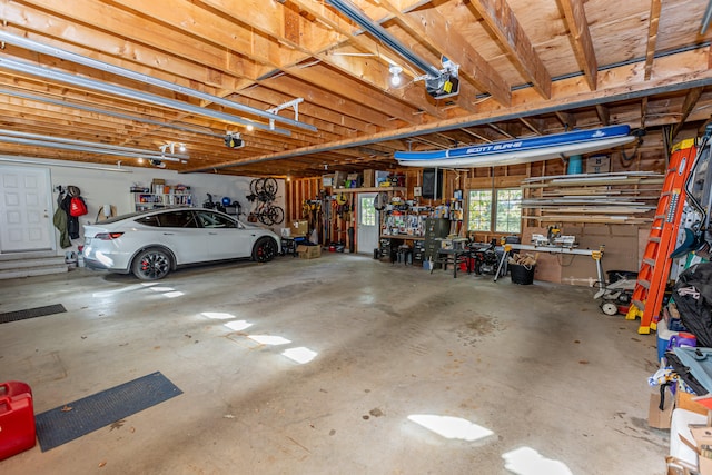 garage featuring a garage door opener and a workshop area