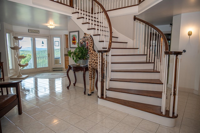 tiled foyer featuring a towering ceiling