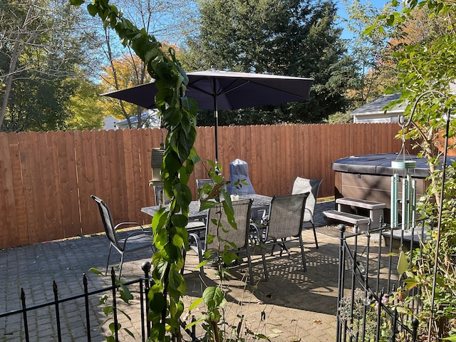 view of patio / terrace with a hot tub