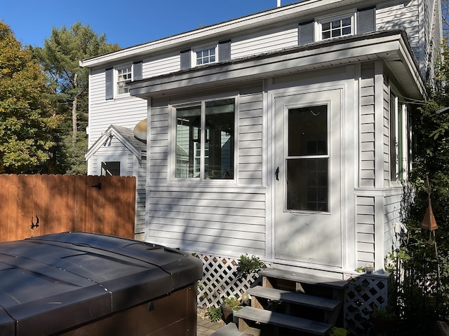 view of property exterior with a hot tub