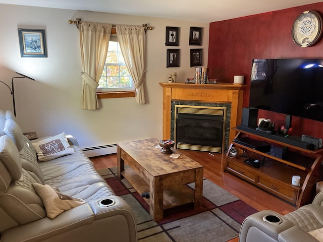 living room with a baseboard radiator, hardwood / wood-style floors, and a premium fireplace