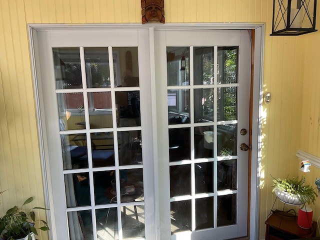 entryway featuring wood walls