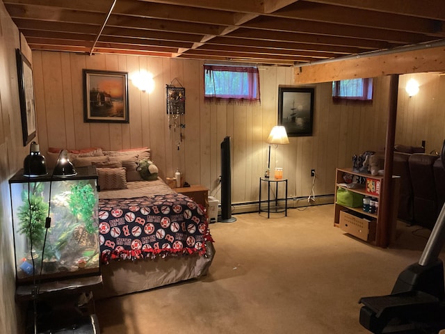 carpeted bedroom with wood walls and a baseboard radiator