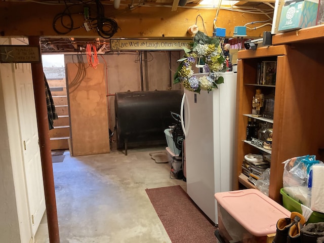 basement featuring white fridge