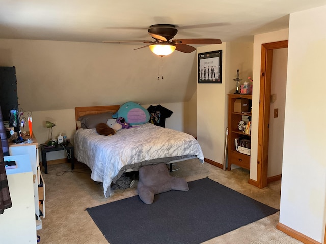 bedroom with lofted ceiling, light colored carpet, and ceiling fan