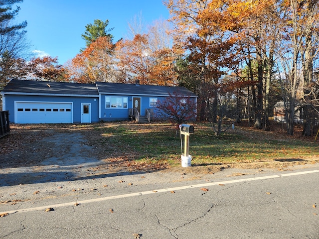 view of front of property with a front lawn and a garage