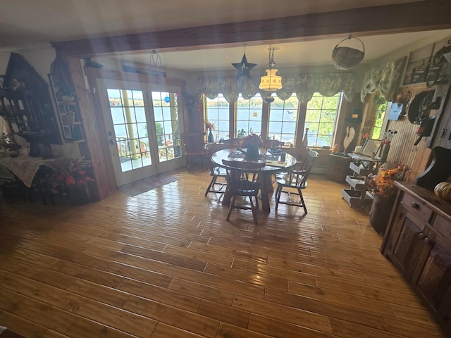 dining room featuring hardwood / wood-style floors and beam ceiling